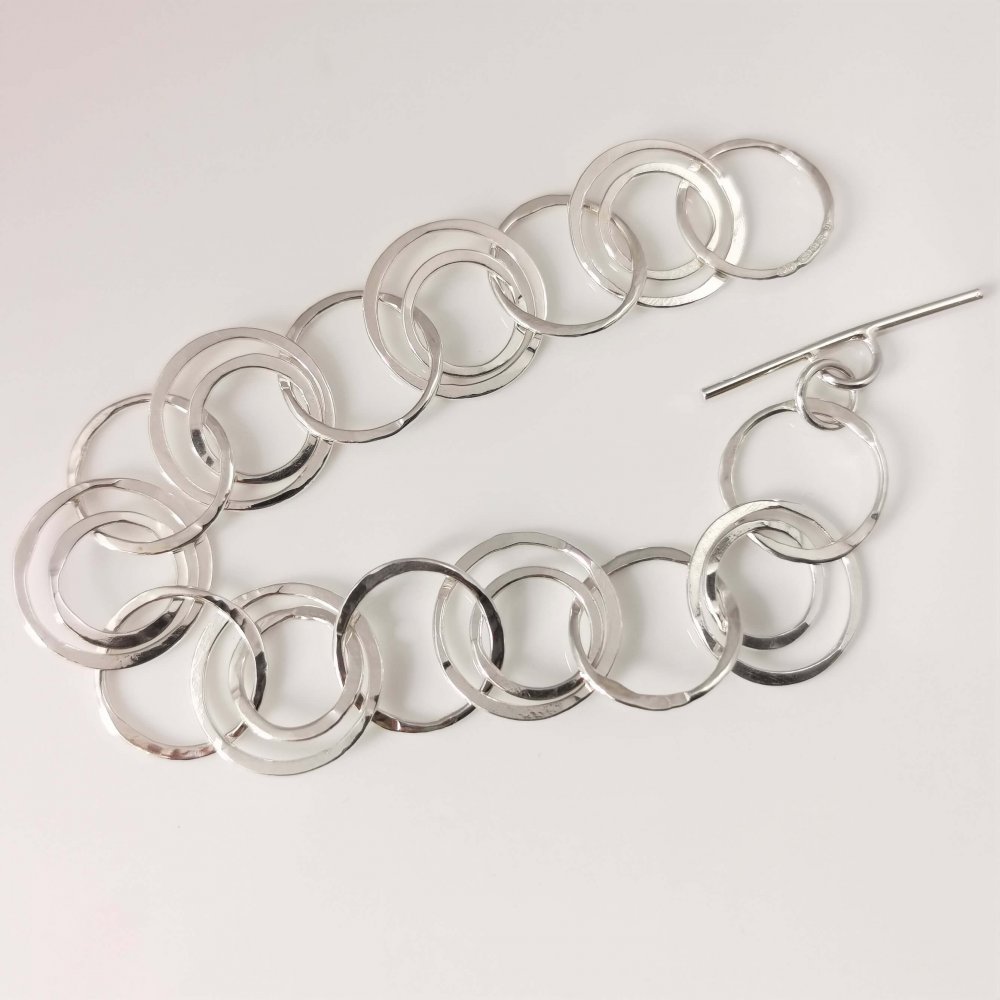 1. A Silver Interlinking Hammered Hoop Bracelet