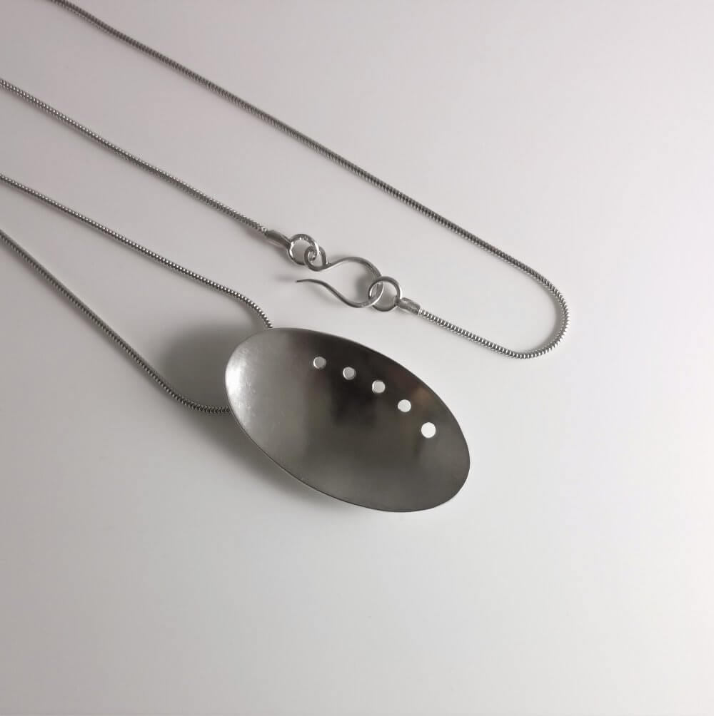 2. A Curved Elliptical Silver Pendant with Asymmetric Design