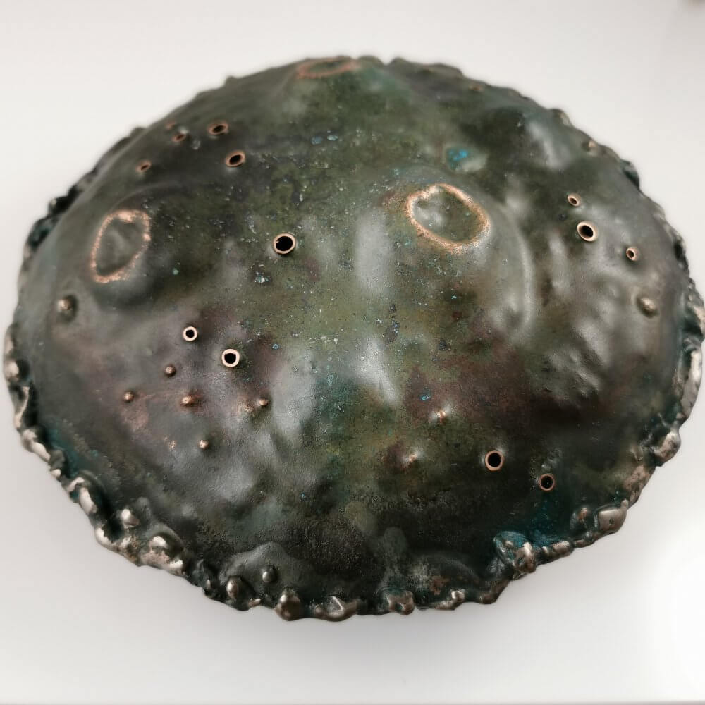 4. A Large Patinated Copper Hollow Discoid Form